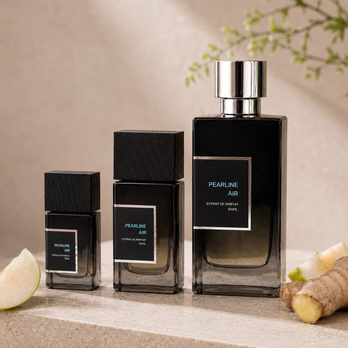 SOVRAI Pearline Air perfume size lineup with 30 mL, 50 mL and 100 mL extrait de parfum bottles beside pear and ginger on a warm neutral studio background.
